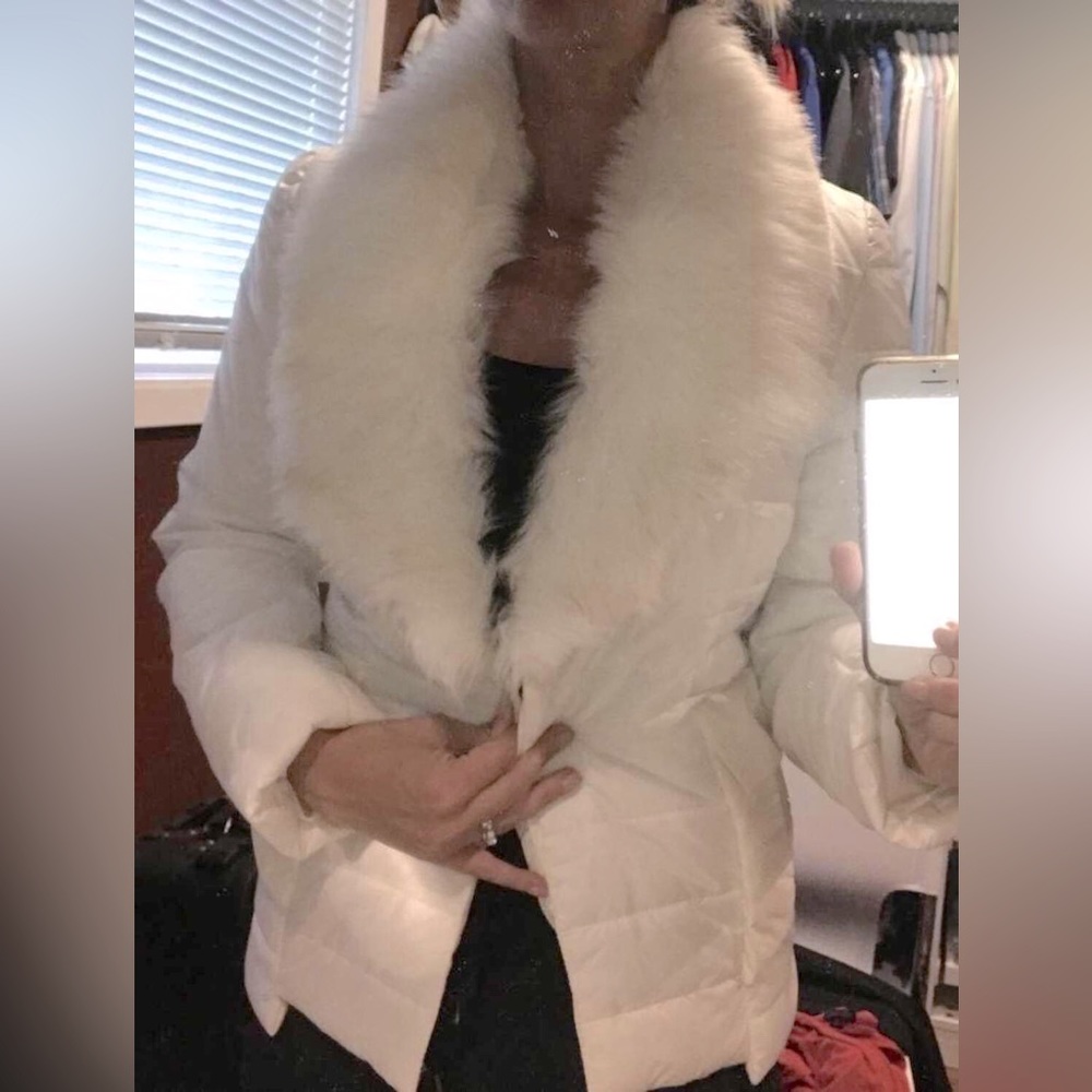 Small white puffer jacket with faux fur collar.